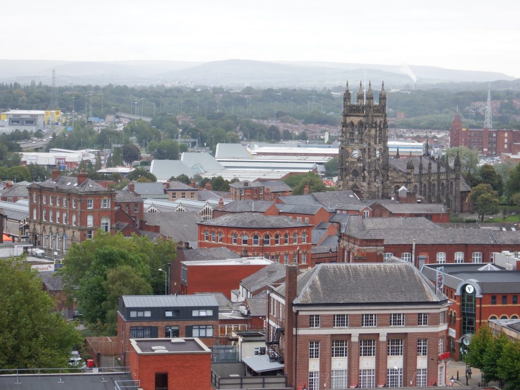 View from 40 metres hieght of the Market Hall, St. Mary's Church, Vernon Mill and rolls hills in the background