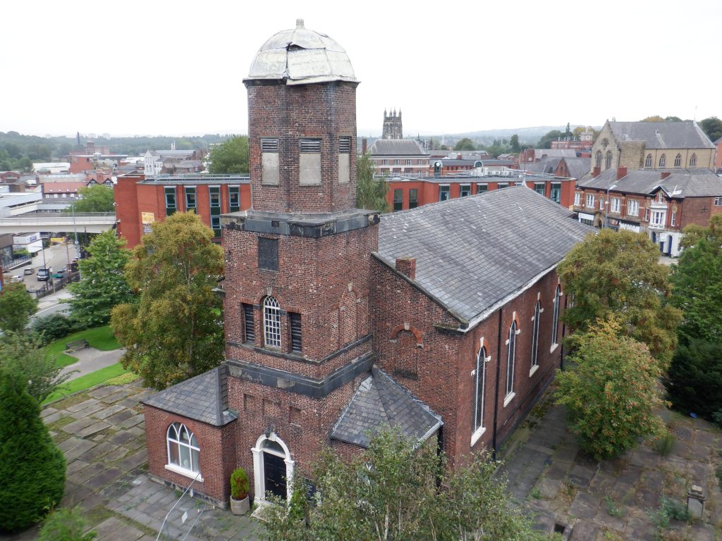 St. Peter's tower and church viewed level with the roof. A large piece of lead on the dome hangs precariously.