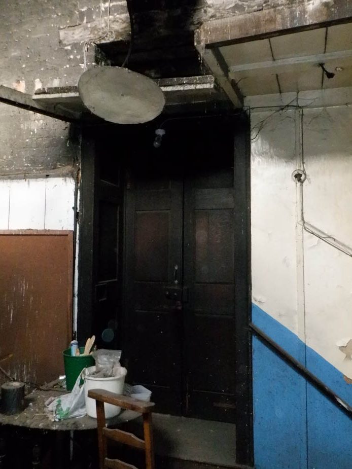 Dark wooden doors to the gallery